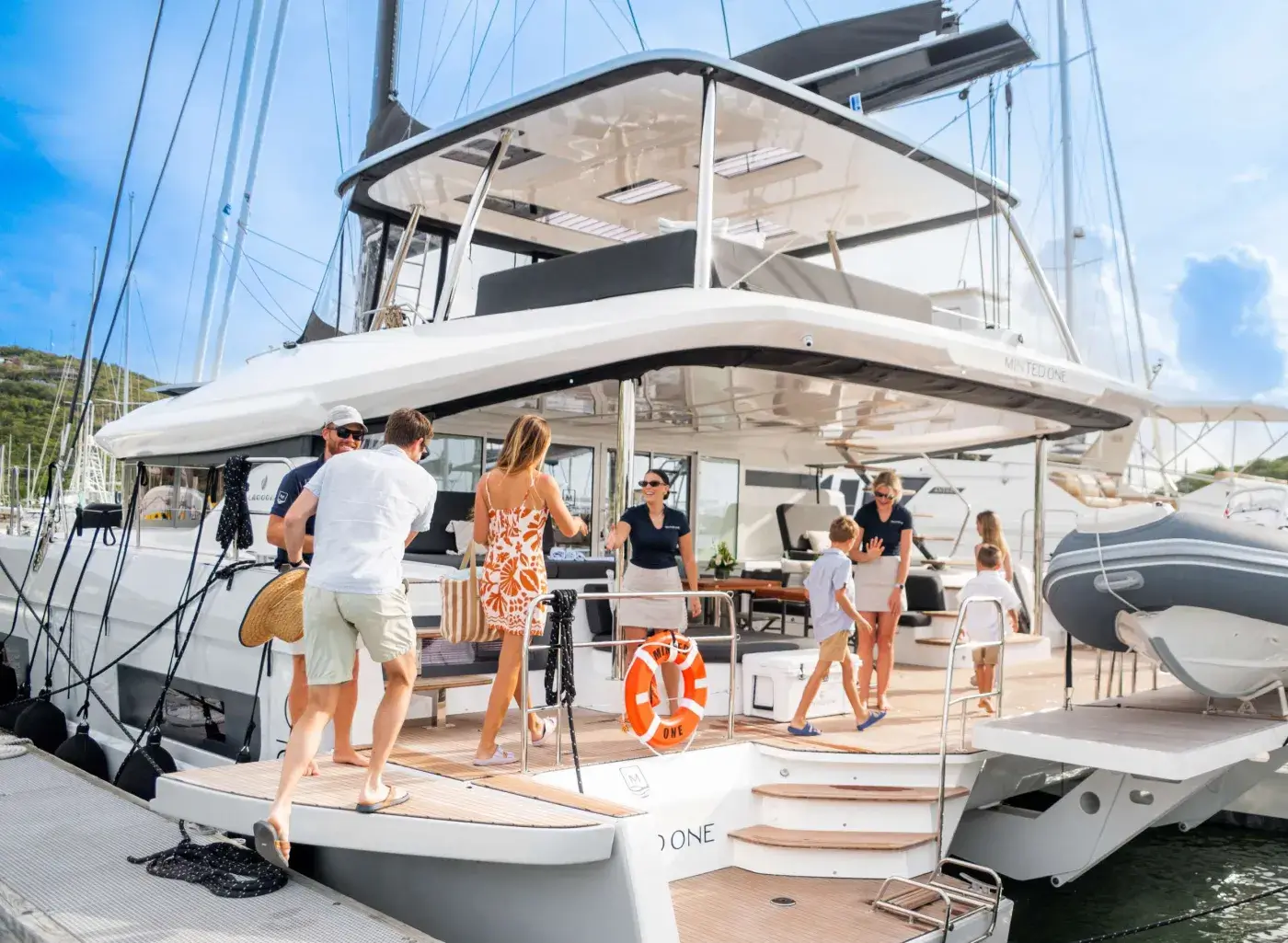 Guests stepping aboard a crewed catamaran at the dock